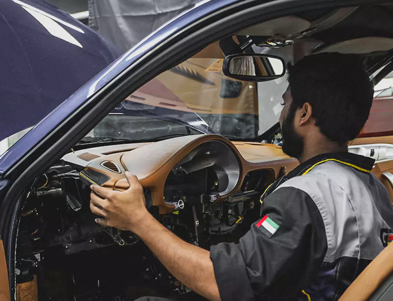 A German Expert Fixing the Car Dashboard