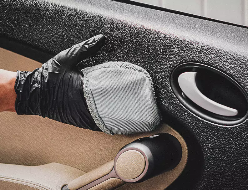 A Man Cleaning the Car Door Interior