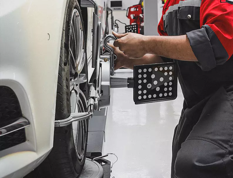 A German Expert Fixing the Car Tyre Allignment