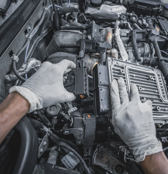 German Expert Fixing the Car Engine Unit