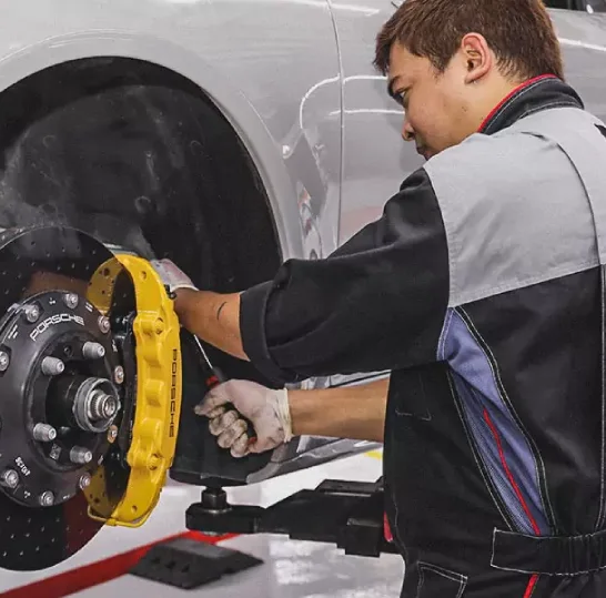 German Expert Fixing the Car Wheel Brake