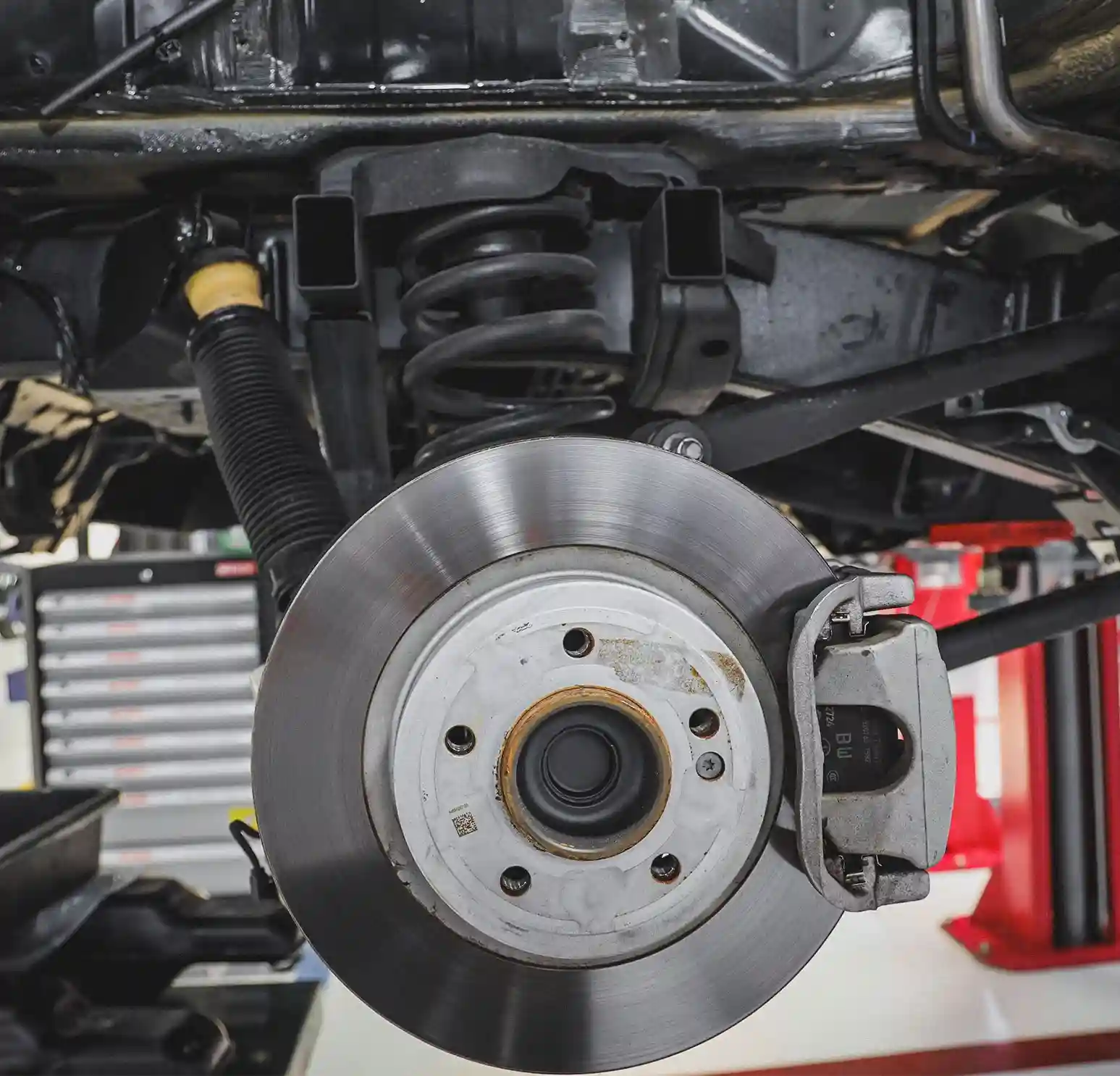 A German Expert Checking the Car Suspenion