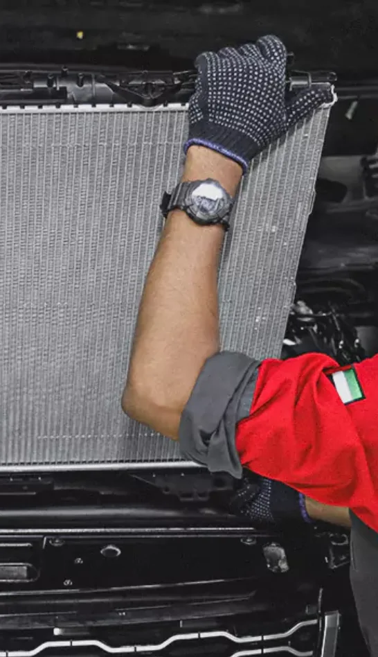 Two Worker Holding the Car Radiator