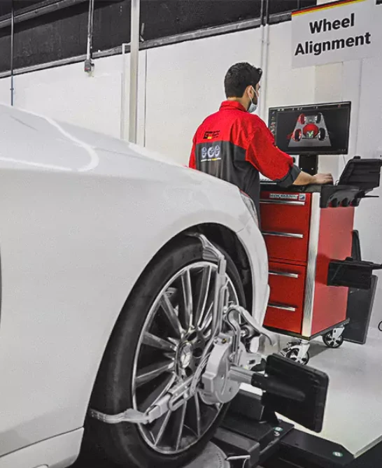 German Expert Checking the Wheel Alignment on Computer Lcd