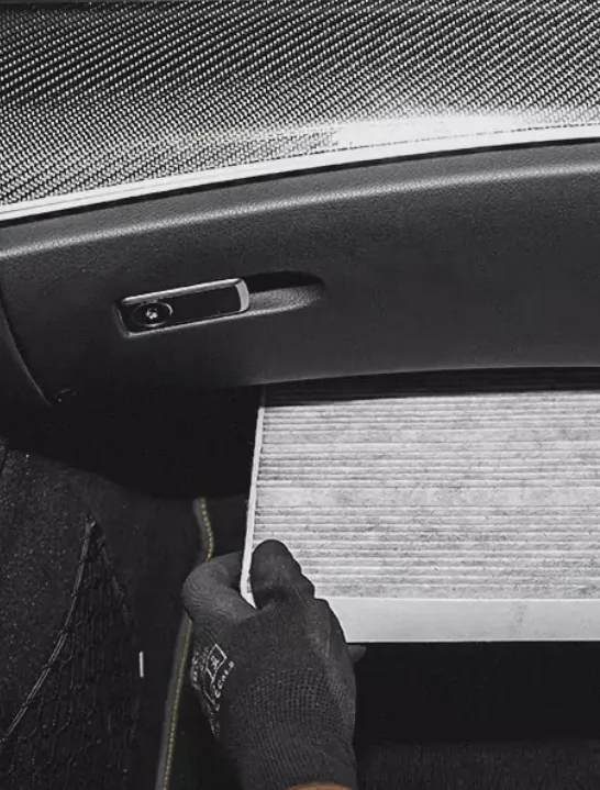 A Worker is Fixing the Car Air Filter