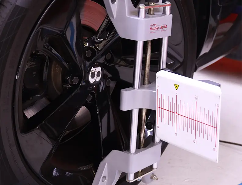 One German Expert Checking Radar Calibration in White Mercedes