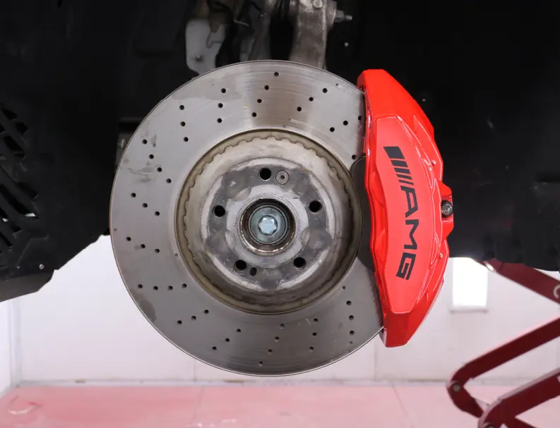 A Man Carrying Tyre to repair Rim & Caliper Painting